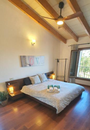 a bedroom with a large bed with two slippers on it at SON FRED CAMPOS in Campos