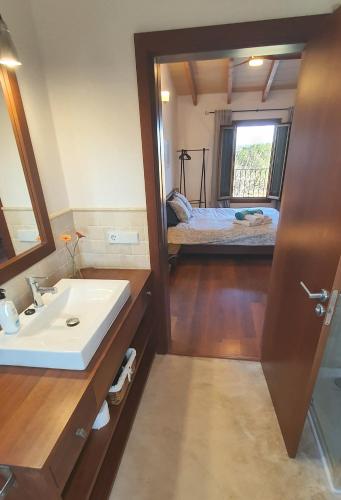 a bathroom with a sink and a bed in a room at SON FRED CAMPOS in Campos