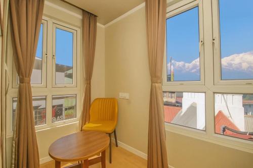 a room with a table and a chair and a window at HOTEL CLIFFTON ROYALS in Darjeeling