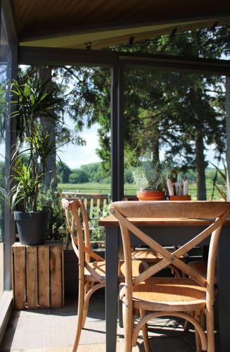 a table and chairs on a porch with plants at The Saracens Head in Stafford