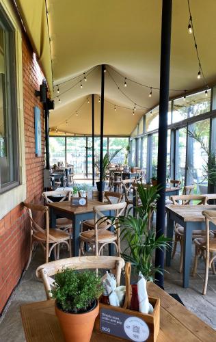 a restaurant with tables and chairs and windows at The Saracens Head in Stafford