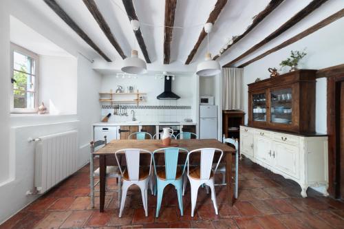 a kitchen with a wooden table and chairs at Casa Rural Ulle Gorri in Unzá