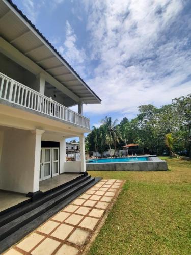 a view of a house and a swimming pool at Silver Lake Villa & Boat Safari in Balapitiya