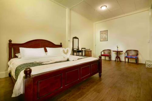 a bedroom with a large bed and a wooden floor at Whole House - 4Bedrooms - Experience Local Life in Bangkok