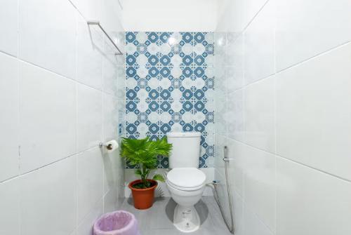 a bathroom with a toilet and a plant in it at Whole House - 4Bedrooms - Experience Local Life in Bangkok