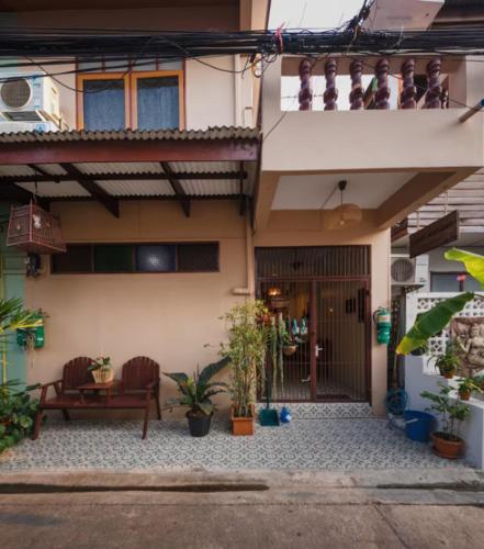 a building with a bench and plants in front of it at Whole House - 4Bedrooms - Experience Local Life in Bangkok