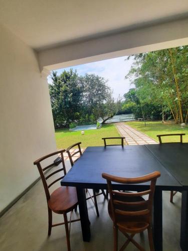 a dining room with a blue table and chairs at Silver Lake Villa & Boat Safari in Balapitiya