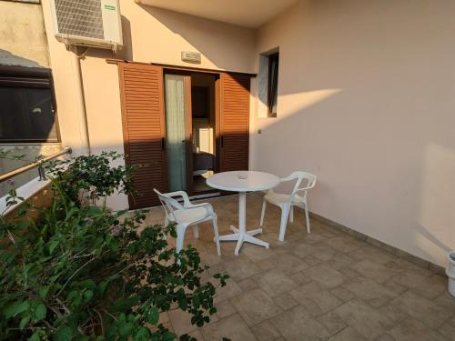 a patio with a table and two chairs at Sartoupoli in Sarti