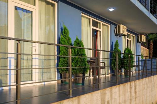 a balcony with potted plants on a building at Guest House 99 in Batumi