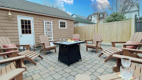 a patio with chairs and a table and a fence at Saltwood House in Cape May