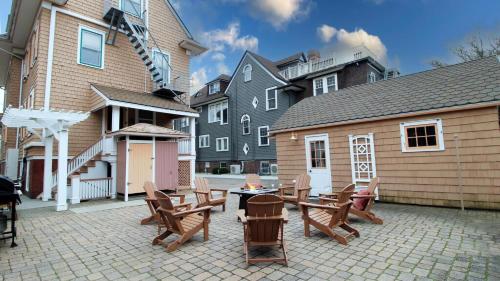 a patio with chairs and a table and a building at Saltwood House in Cape May
