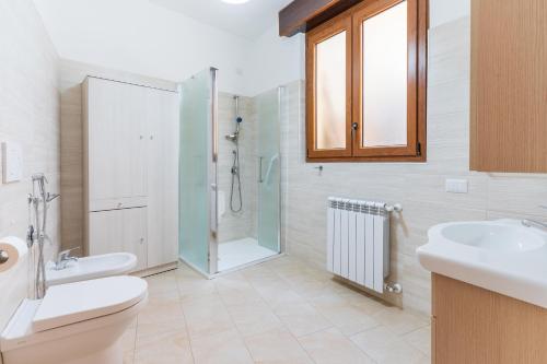 a bathroom with a shower and a toilet and a sink at Da Zia Vittoria - Affitti Brevi Italia in Ulassai