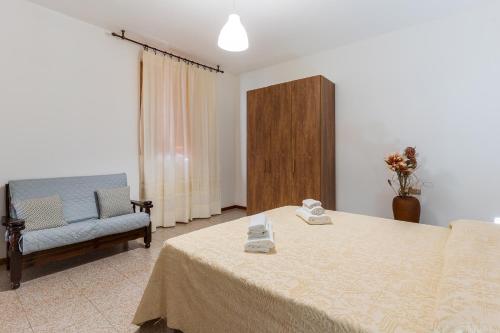 a room with a bed and a chair and a table at Da Zia Vittoria - Affitti Brevi Italia in Ulassai