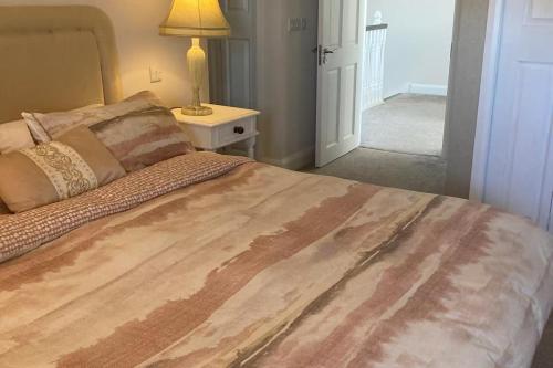 a bedroom with a bed and a lamp on a table at Luxury Galway Getaway with 5 Bedrooms in Galway