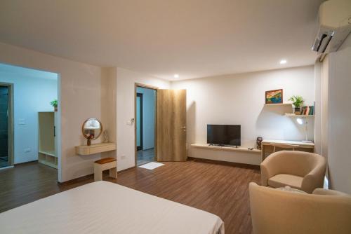 a living room with a bed and a television at LiJu's House - Access to Hanoi Centre, Full Kitchen in Hanoi