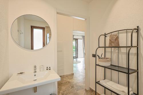 a bathroom with a sink and a mirror at Tenuta Poggio Piero in Montemassi