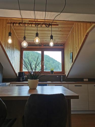 a kitchen with a table and a large window at Haus Maria in Campolasta