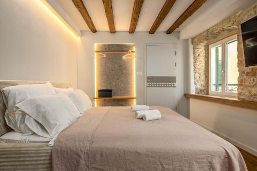 a bedroom with a bed with two towels on it at Diocletian's Suites Centre Palace in Split