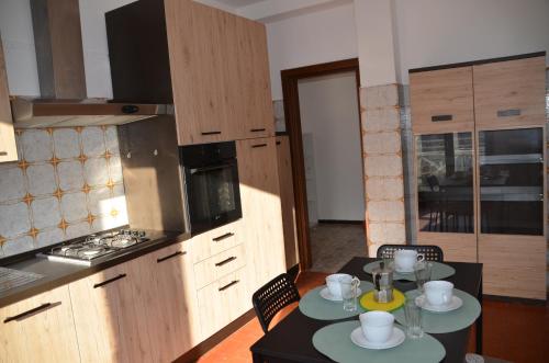 a kitchen with a table with two plates on it at Top Floor Apartment 5 minutes walk to lake in Malgrate