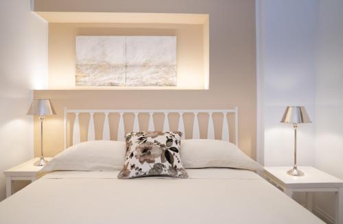 a white bed with a pillow on top of it at Il Torrione Relais in Sirolo