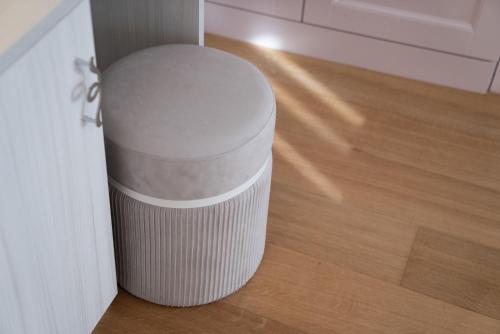 a white trash can sitting in the corner of a room at Il Torrione Relais in Sirolo