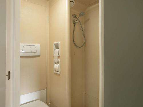 a bathroom with a shower and a toilet at B&B HOTEL Berlin Genshagen-Nord in Genshagen