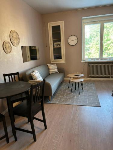 a living room with a couch and a table at Central Studio in Vaasa with Free Parking in Vaasa