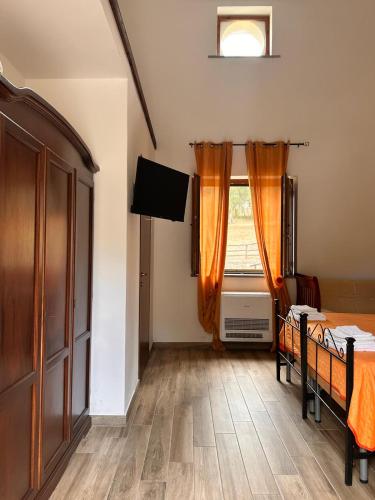 a bedroom with a bed and a window at Agriturismo Nonno Ninuccio in Gioi