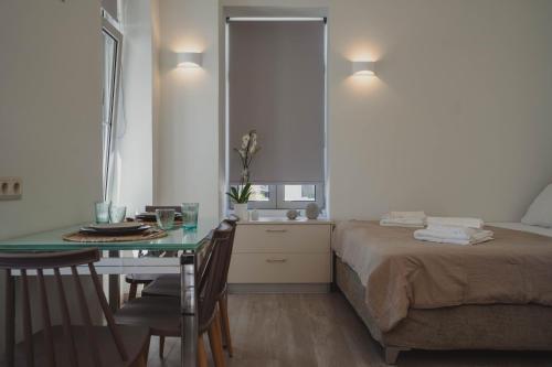 a bedroom with a bed and a table and a sink at Ionis Apartment 1 in Karistos