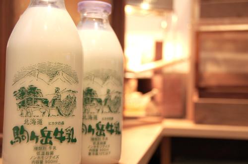 two bottles of milk sitting next to each other at Hotel Global View Hakodate in Hakodate