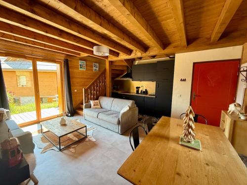 a living room with a couch and a table at Cozy Mountain Cottage Pra loup in Uvernet-Fours
