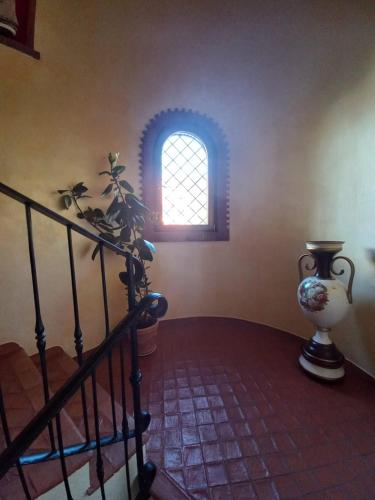 a staircase with a vase and a window at Villa Orchidea in Praia a Mare
