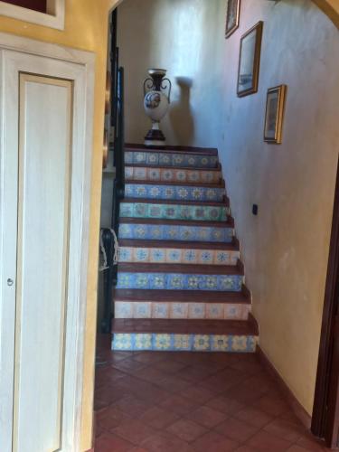 a staircase in a house with a vase on the wall at Villa Orchidea in Praia a Mare