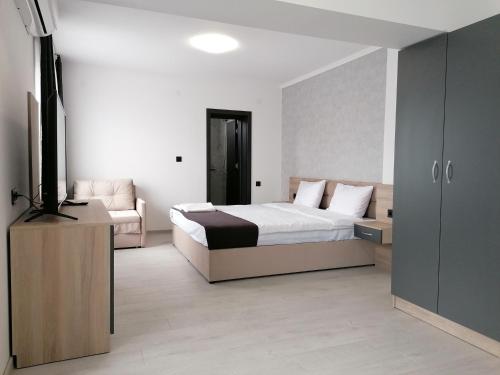 a hotel room with a bed and a couch at гест хаус паркова 33 in Razgrad