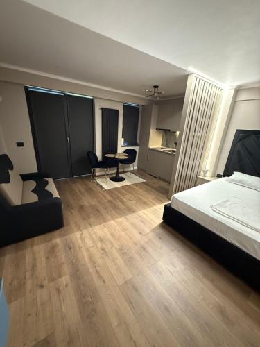 a bedroom with a bed and a desk and a table at Noble Stay in Saturn