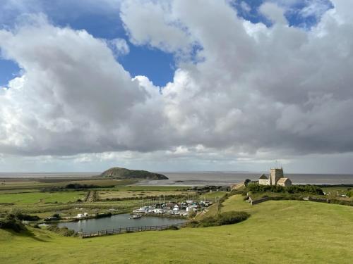 a view of a village and a body of water at Barleycombe in Loxton
