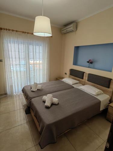 a bedroom with two beds with towels on them at Sartoupoli in Sarti