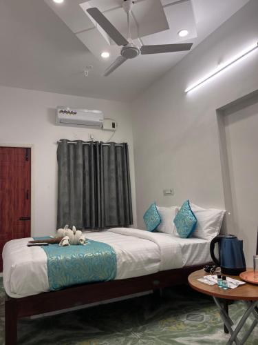 a bedroom with a bed with a stuffed animal on it at THE CHALET, formerly as THE EDEN VILLA in Pūrnānkuppam