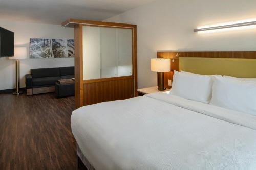 a hotel room with a bed and a couch at SpringHill Suites by Marriott Lake Charles in Lake Charles