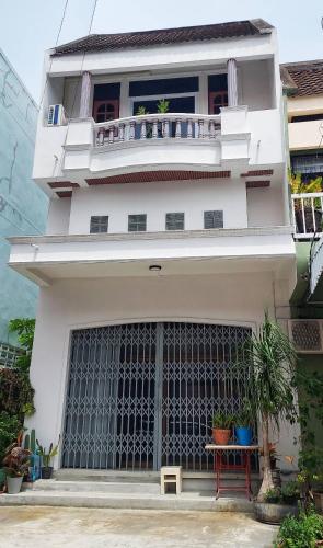 a white building with a large gate in front of it at Choltara house in Hat Yai