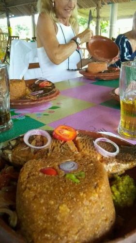 a woman sitting at a table with a plate of food at Hôtel Chez Jules 229 