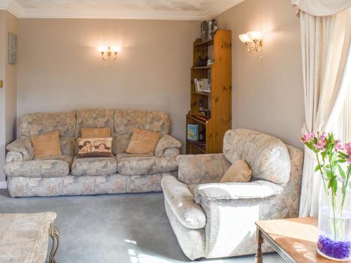 a living room with a couch and two chairs at Meadow View in Hockering