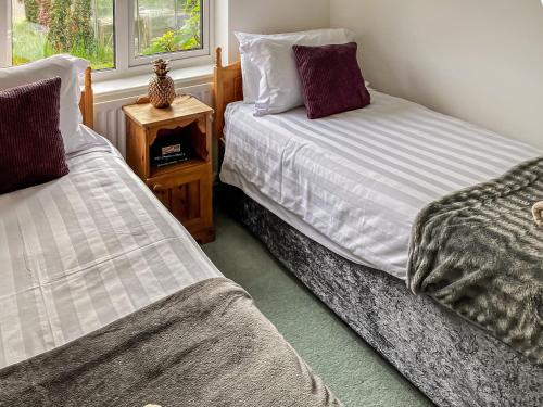 two beds sitting next to each other in a room at Meadow View in Hockering