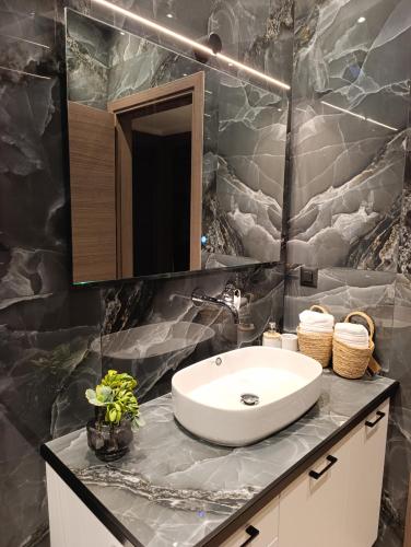a bathroom with a sink and a mirror at Apagio Suite in Argostoli