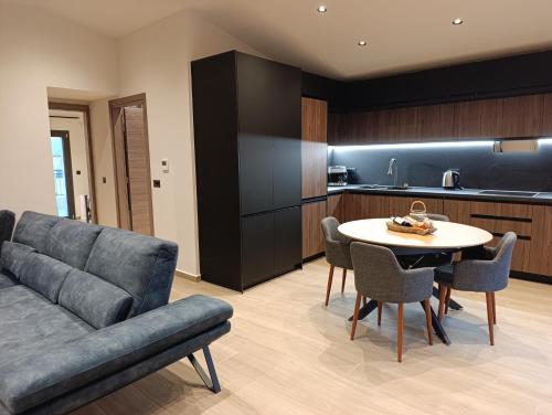 a living room with a couch and a table and a kitchen at Apagio Suite in Argostoli