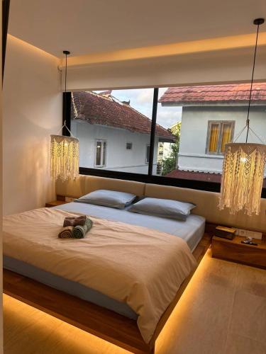a bedroom with two beds and a large window at Dreamland View Villa #3 with Pool in Uluwatu