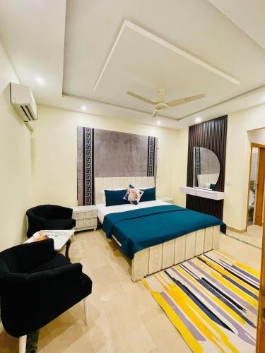 a bedroom with a large bed and a couch at Dream Lodge House in Islamabad