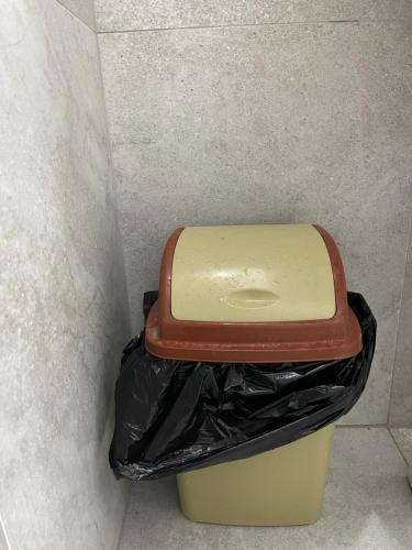 a trash can with a brown toilet in a wall at Gazi’s Apartament for Rent in Golem
