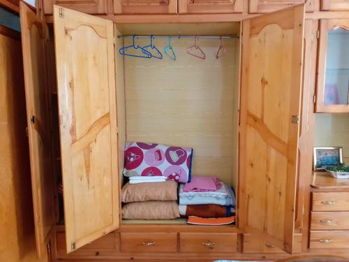 a wooden cabinet with a bed inside of it at Dar Al-Amira - Fnideq Beach Apartment in Fnidek