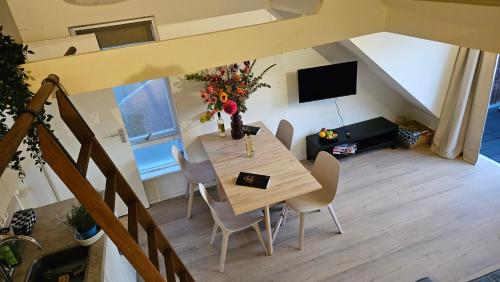 an overhead view of a dining table and chairs in a living room at Amsterdam ZaanseSchans House in Krommenie
